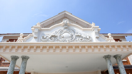 Low Angle View of Ornate White Classical Building Facade with Decorative Pediment © Belva