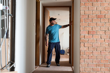 Fototapeta premium Construction worker inspecting hallway renovation