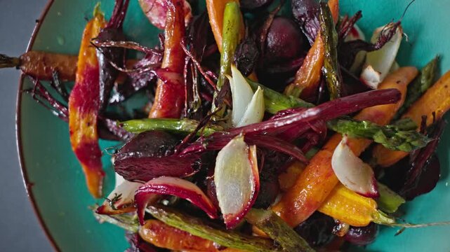 High-angle close-up of a colorful vegetarian dinner featuring caramelized, oven-baked seasonal root vegetables. An organic, fiber-rich dish perfect for healthy lifestyle, weight loss diet, and culinar