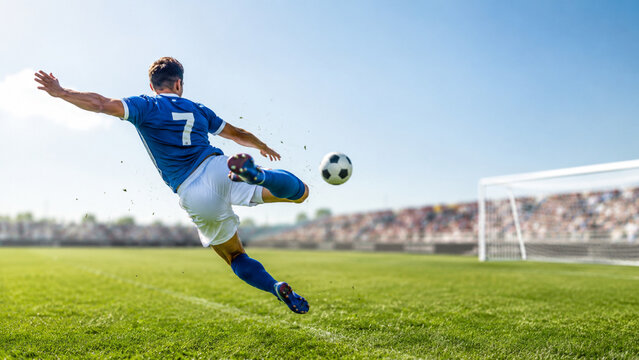 Professional soccer player kicking ball in mid air towards the goal post on a lush green field under a clear blue sky during a sunny day match, high quality sports action photography