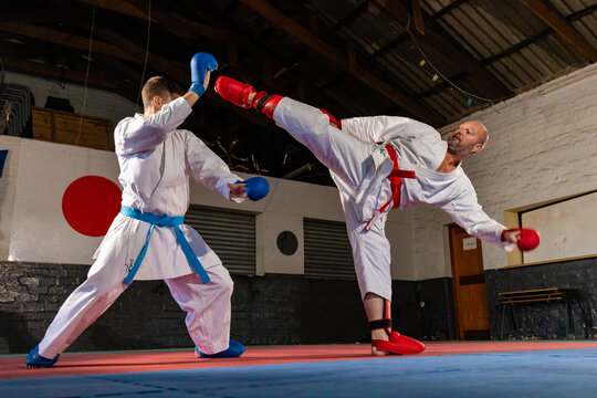 Karate sparring match with high kick technique