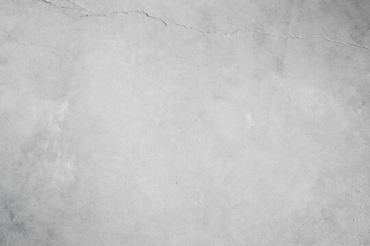 High-resolution light gray concrete wall texture with a subtle vintage crack. Blank grunge cement surface background. Perfect empty backdrop for minimalist product mockups, industrial advertising