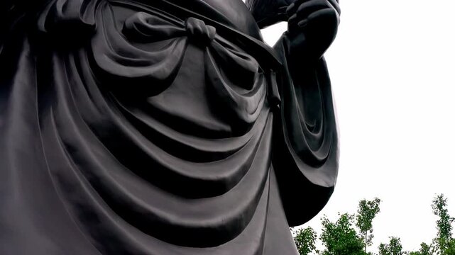 Majestic black Buddha statue at Bai Dinh Pagoda, Ninh Binh, Vietnam; spiritual Buddhist religious landmark and ancient cultural heritage site.