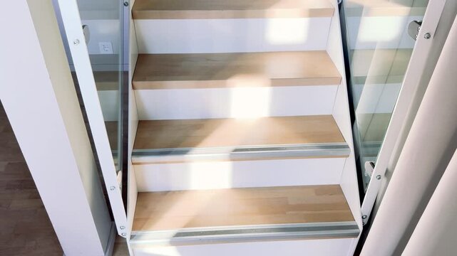 Low Angle Zoom of Sun Light Hitting Nordic Wooden Stairs to Loft