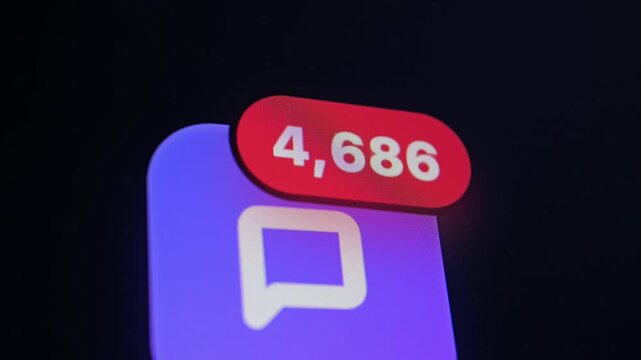 A close-up of a purple chat app icon on a dark screen with a red notification badge showing high counts of unread messages.