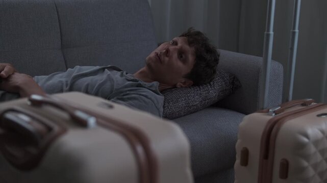 Quiet burnout and emotional depletion. Man lying on bed staring into space, mentally exhausted and unable to recover