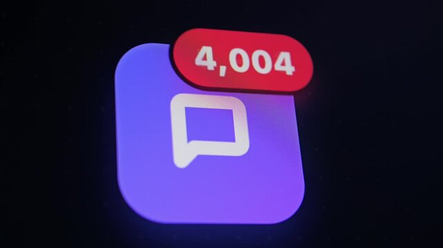 A close-up of a purple chat app icon on a dark screen with a red notification badge showing high counts of unread messages.