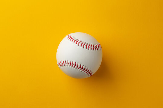 Classic White Baseball with Red Stitching on Bright Yellow Background