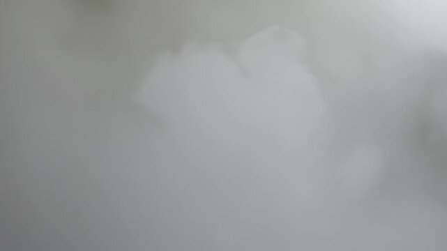 Billowing dense white vapor plumes filling neutral gray box, coalescing and rising from emitter