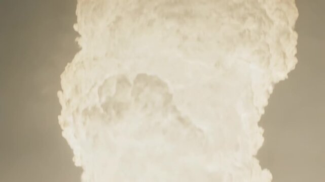 Rising dense luminous plume evolving from bright base in test area, showing billowing cloud lobes