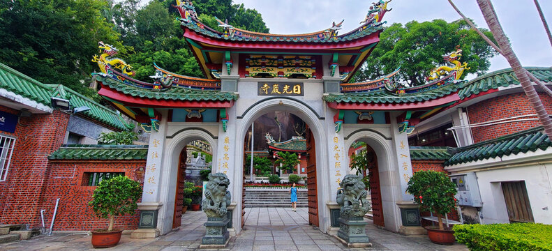 Ornate Chinese Temple Gate with Dragon Roof and Stone Lions