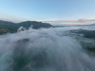 Naklejka premium Foggy Mountain Valley at Sunrise