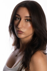 Fototapeta premium Young woman looking at camera, showcasing beauty and fashion in a studio setting