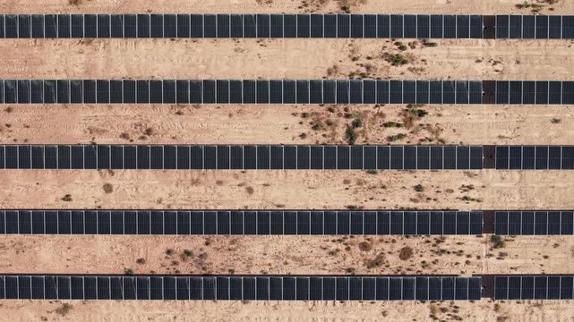 Top down aerial view of solar panel rows forming a geometric grid pattern in Mendoza, Argentina.