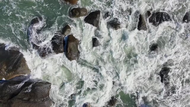 Tropical beach with waves hitting on the rocks at Brazil