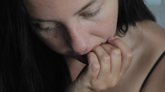Anxiety and stress coping behavior with woman biting nails in close up, self soothing and emotional regulation failure concept