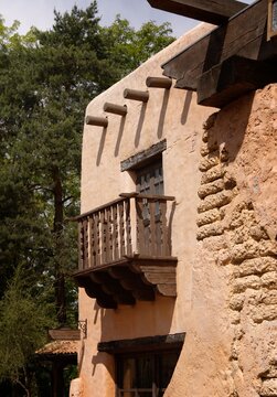 Traditional adobe building with a charming wooden balcony