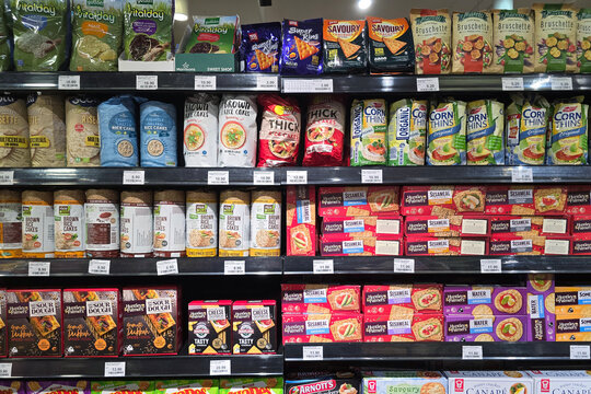 Bayan Lepas, Malaysia - May 14, 2026: A variety of packaged rice cakes, corn thins, and savory crackers on shelves at a Mercato grocery store healthy snack aisle.