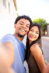Fototapeta premium Happy couple taking a close selfie in natural light