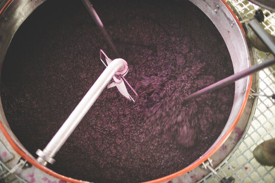 Red Wine Grape Must Being Mixed in Stainless Steel Fermentation Tank