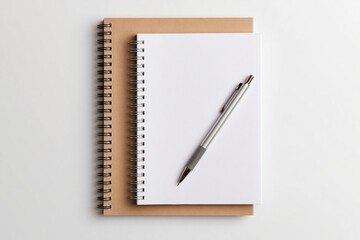Naklejka premium Notebook and spiral stationery with a pen on a blank white office paper background