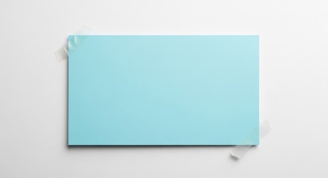 A rectangular light blue paper note attached with two pieces of clear adhesive tape isolated on white background