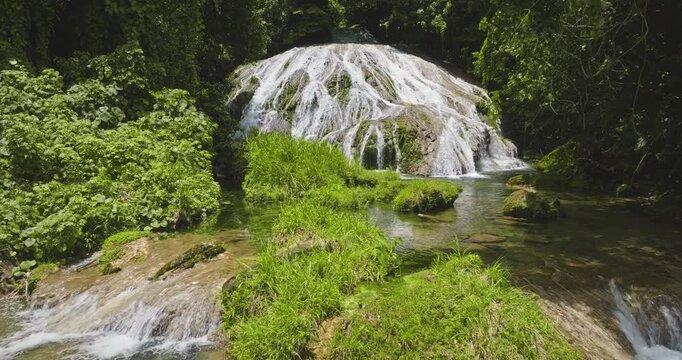 Mele Cascades waterfall creates clear pools and streams, surrounded by lush green foliage and tropical jungle vegetation on Efate Island, near Port Vila, Vanuatu. Remote natural landscape. Slow motion