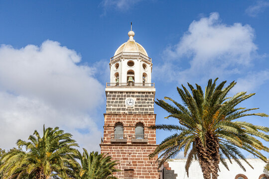 The bell tower of Iglesia de Nuestra Se&ntilde;ora de Guadalupe in the Historic Village La Villa de Teguise the former capital city of the Canary Island of Lanzarote, Spain