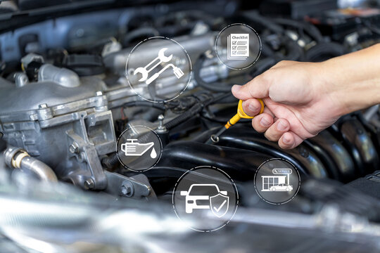 Automotive maintenance concept, Technician checking engine oil level with dipstick during vehicle inspection, preventive service, warranty coverage, and routine car care for optimal performance