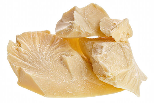 Chunks of Raw Organic Cocoa Butter on Dark Surface
