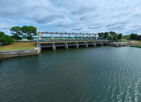 Aerial view of the Tail Sluice flood defense gate and river barrier on the River Great Ouse in King's Lynn, UK