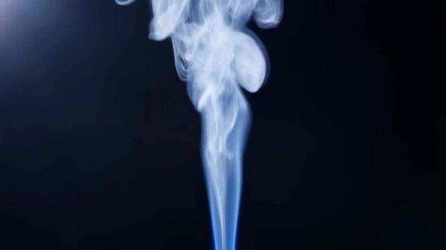Ethereal blue smoke rising gracefully against a dark background. Represents tranquility, mystique, and the beauty of natural elements in motion