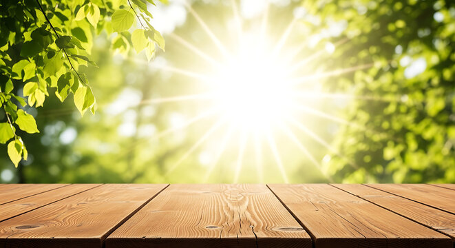 Empty wooden table top surface against blurred natural green forest background with sunny rays background sunlight template