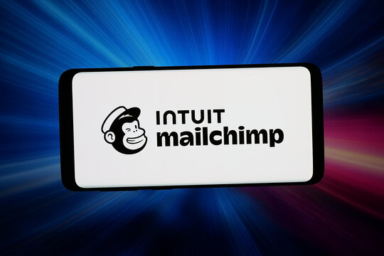 Stuttgart, Germany - 06-10-2026: In this photo illustration, the logo of marketing software Mailchimp (Intuit) is displayed on a smartphone in front of abstract background on computer screen.