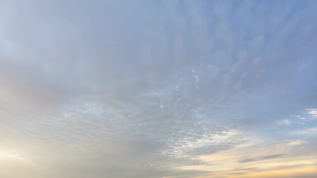 Expansive sky with soft clouds transitioning from blue to warm hues at sunset. A serene backdrop for nature and tranquility themes