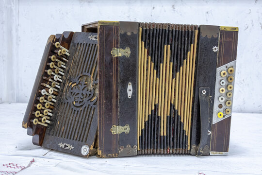 Hand harmonics are musical instruments that form the basis of a family of harmonics. A musical folk instrument. An antique accordion.