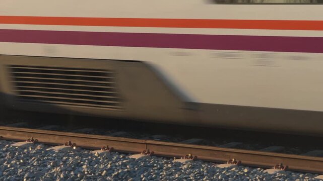 Fast Passenger Train Blurring Past Railway Platform