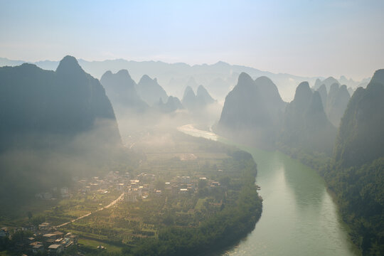 Misty Li River winding through karst mountains in Yangshuo, Guilin, Guangxi, China