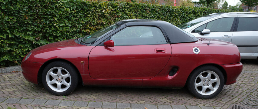 Nijkerk, Netherlands - Oct 14 2024 Side view on a parked red MG from 1997. It's a MGF