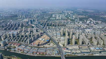 Aerial view of modern high-rise residential district and canal in a Chinese city © TrieuHao