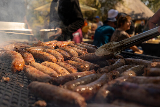 Boerewors and Sausages Grilling on Large Outdoor Braai