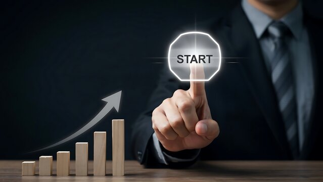 Businessmans finger presses a glowing start button next to increasing business growth graph