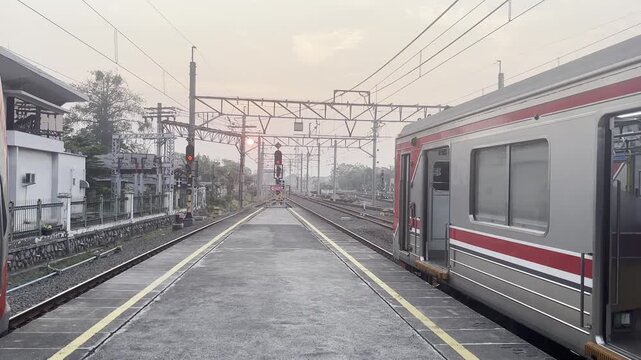 Train driver entering the driver cabin of a commuter train, representing railway operations, transportation, and professional work activity.