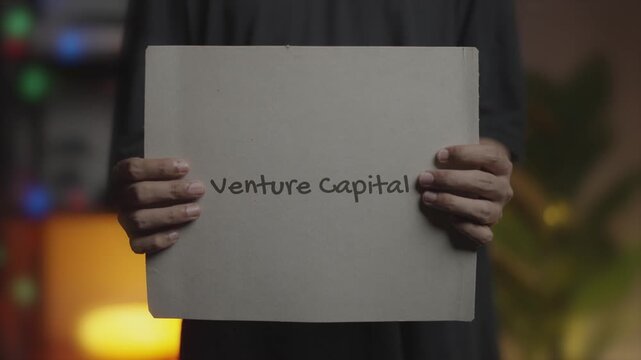 Venture Capital Written on Banner &ndash; Man Holding Placard