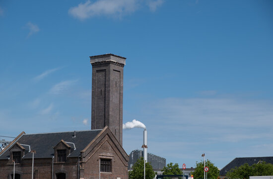 Historic Industrial Brick Tower and Modern Smokestack in Copenhagen