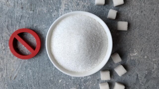 The sugar ban sign as a concept to stop the problem of diabetes and obesity, a call to diet. The sugar ban sign as a background for your design