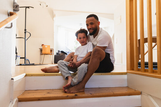 Happy father and son bonding on home wooden steps