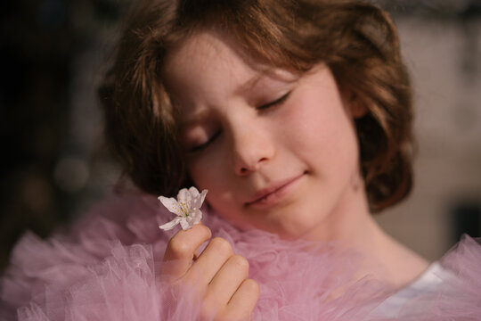 Young child playing under flowering cherry tree