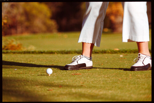 Golf Swing in Progress on the Course With Focus on Player&rsquo;s Feet