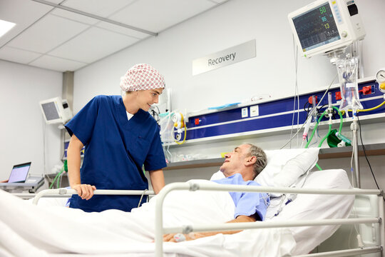 Doctor Talks With Patient in Hospital Recovery Room